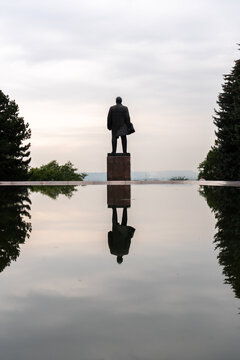 Silhouette of statue of Lenin from behind