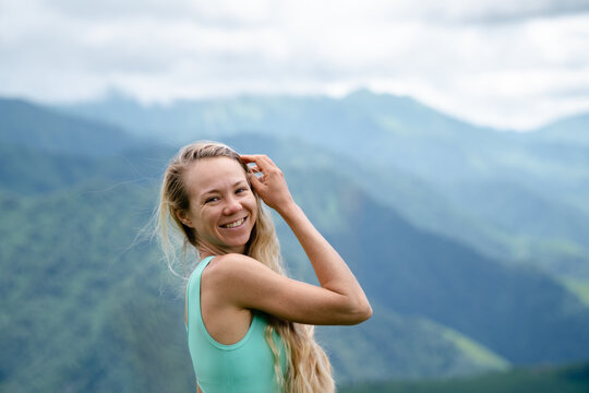 A Slender blond girl in Georgian mountains