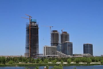Fototapeta na wymiar Skyscraper buildings under construction on the lake shore in China
