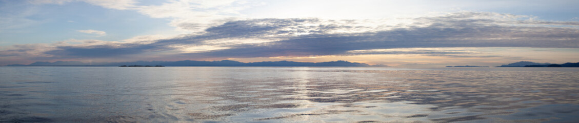 A beautiful panoramic sunset looking across Georgia Straight at Vancouver Island (Nanaimo) from the Sunshine Coast, British-Columbia on a calm day