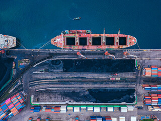 Russia, Primorsky Krai, Vladivostok, Aerial view of industrial ship moored in coal loading dock
