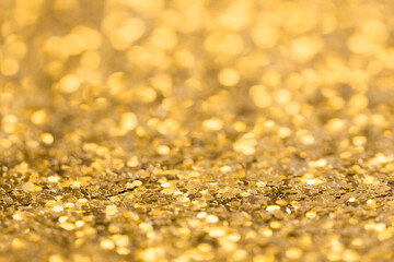 Abstract festive gold background. Blurred glitter texture.