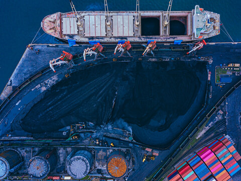 Russia, Primorsky Krai, Vladivostok, Aerial view of industrial ship moored in coal loading dock