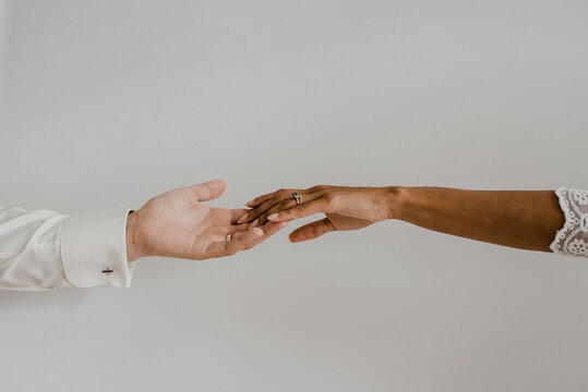 Cropped Image Of Couple Hand Against Wall