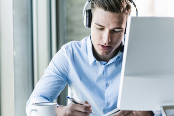 Close-up of male customer representative wearing headset while working in call center