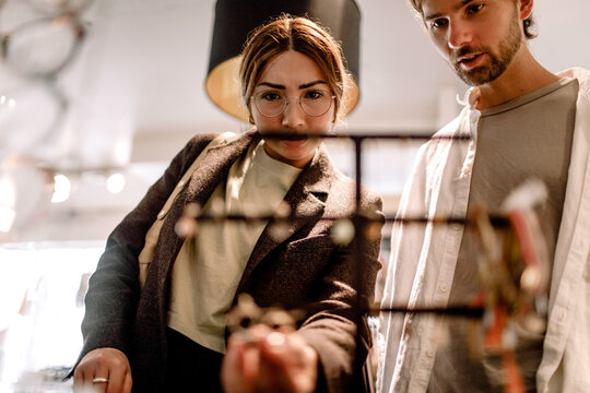 Man and woman looking at eyewear in retail store