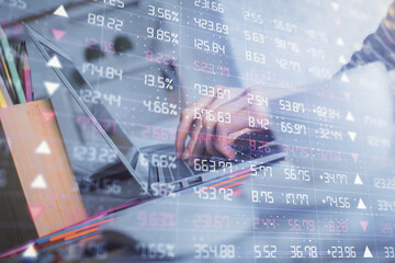 Double exposure of woman hands typing on computer and forex chart hologram drawing. Stock market invest concept.