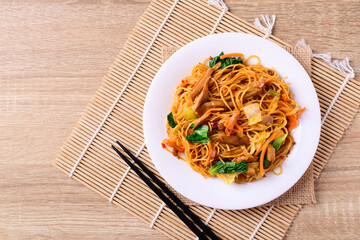 Asian food, vegetarian stir fried noodles with mushroom and vegetables, Top view