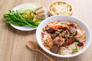 Northern Thai food (Kanom Jeen Nam Ngeaw), Rice noodles spicy soup with pork and pork blood eating with fresh vegetables, Top view
