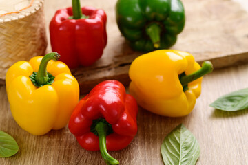 Fresh yellow, red and green bell peppers on wooden background, Organic vegetablesF