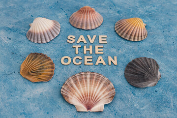 save the ocean text on blue bakground with sea shells, act for climate change concept