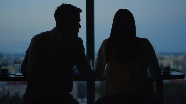 People having rest against city background. Man and woman talking in open space