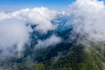 Aerial photography of mountains surrounded by clouds