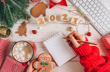 Fototapeta premium Office Workplace with Computer keyboard, empty notebook and Christmas Decoration.