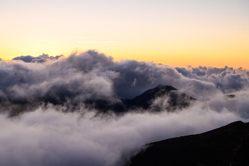 Clouds over mountains seen from the Haleakala volcano. Maui, Hawaii.