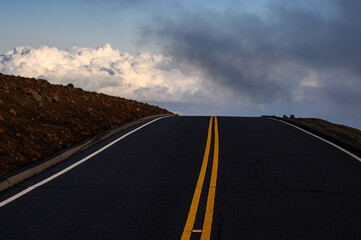 Road and clouds on the horizon seen from inside the Haleakala National Park. Maui, Hawaii.