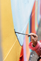 Artist painting a wall with a brush
