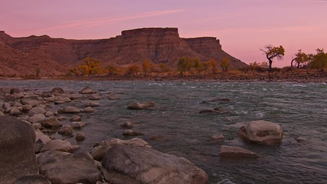Pink sky over the desert landscape in Fall in Utah looking down the Green River.