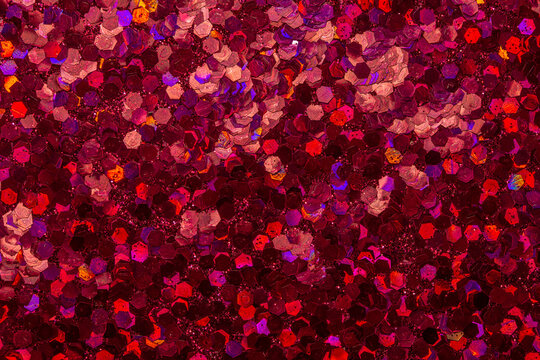 Full frame macro abstract background of sparkling red color glitter texture, with copy space