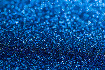 Full frame macro abstract background of sparkling blue color glitter texture, with bokeh and copy space