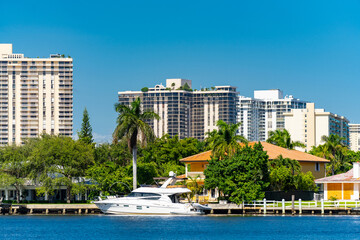 Mansion waterfront yacht with highrise buildings in background