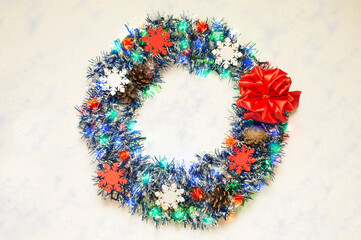 Christmas wreath on a textured surface.