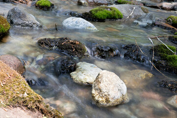 Naklejka na ściany i meble Slow shot of the clear stream flowing in the outdoor mountain