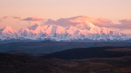 Fototapeta na wymiar Sunset scenery on the snow mountain