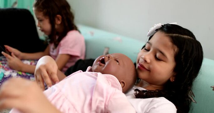 Mix race little girl child hugging black baby doll