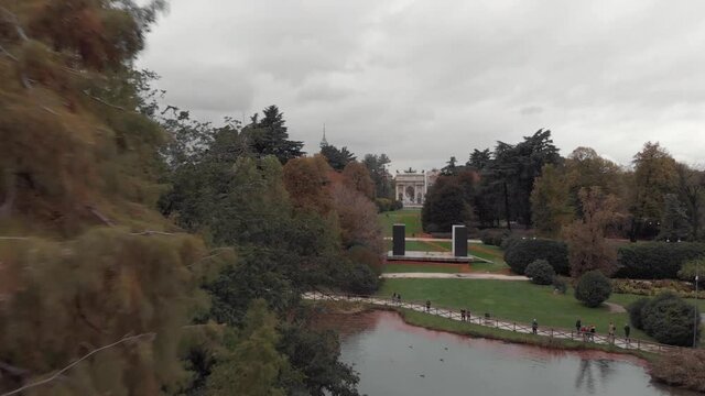 Drone passing trees in Sempione Park, Parco Sempione, Milan