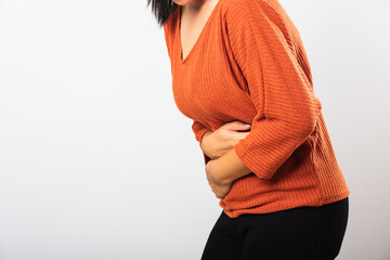 Asian woman she sick have stomach ache holds hands on abdomen, part of body, female having painful...