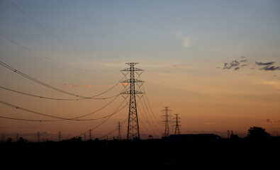 Fototapeta na wymiar High voltage poles at sunset