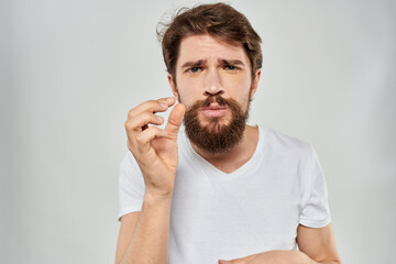 Bearded man gesturing with hand white cropped t-shirt studio lifestyle