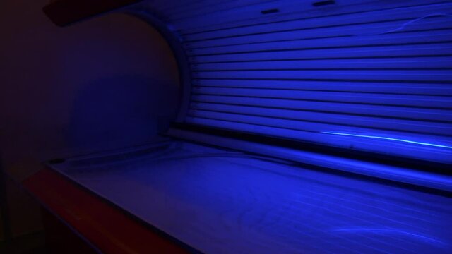 Panning across dark blue tanning bed
