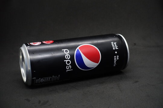 A can of pepsi black against isolated black background