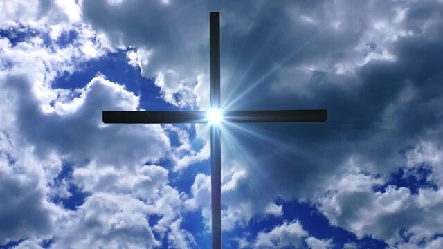 a bright light in the middle of a cross against a cloud background against a clear blue sky.