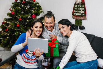 Group of hispanic siblings calling family during quarantine Christmas cellebration in Mexico
