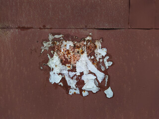 old and empty public bulletin board with the remains of torn papers