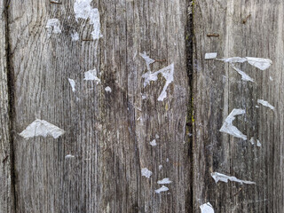old and empty public bulletin board with the remains of torn papers