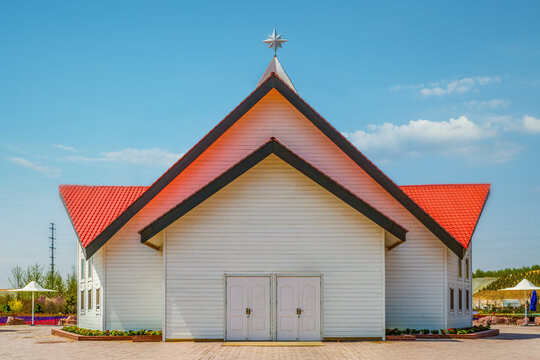 White wooden church building under blue sky
