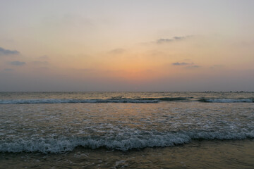 Beautiful view of sea waves flowing into sand at Baga beach in Goa, India