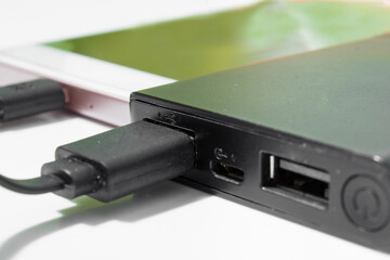 The smartphone included in the powerbank. Theme of phone repair and maintenance.