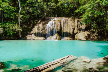 Beautiful blue waterfall with fish swimming in Tropical  forest at Erawan waterfall National Park Kanchanaburi, Thailand.
