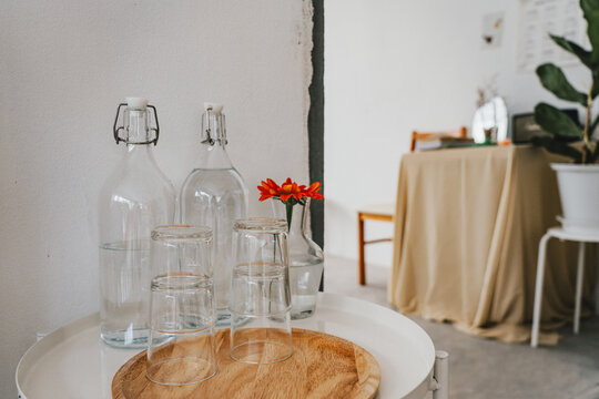 Many Glass Of Water In Bottle On White Table.