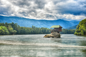 Fototapeta na wymiar Small house on the rock in river. Lonely house on the river Drina in Bajina Basta, Serbia