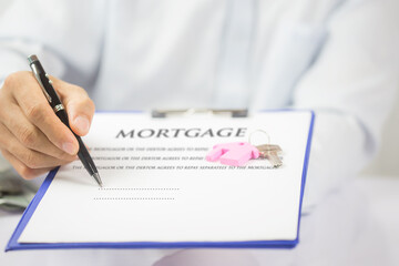 Mortgage concept. Just put your signature here! Confident young man in shirt and tie holding some document.