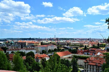 Fototapeta na wymiar Prague and Czech Republic during sunny day. Prague Panorama with blue sky and white cloud. Photo taken from near the Prague Castle.