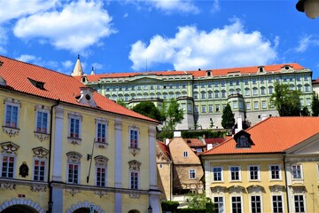 Prague and Czech Republic during sunny day. Ancient church and colorful houses in front of the...