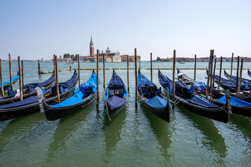 Fototapeta na wymiar Gondolas at the Piazzetta San Marco in Venice with San Giorgio Maggiore in the back