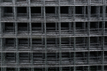 Reinforcement mesh is stacked for use in reinforced concrete construction work. Steel material in the form of a metal mesh for strengthening the wall, floor, floor and foundation. Abstract background